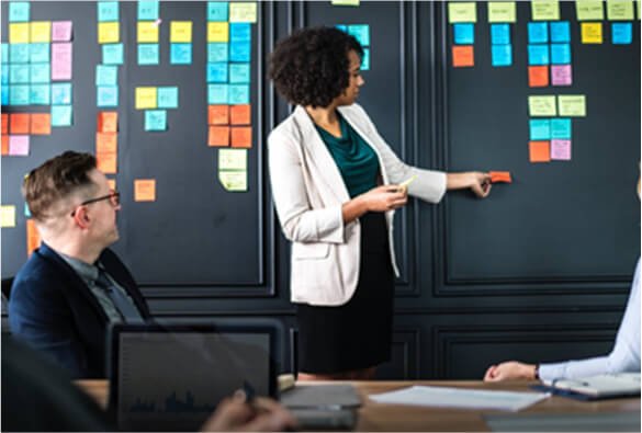 woman-placing-sticky-notes-during-meeting